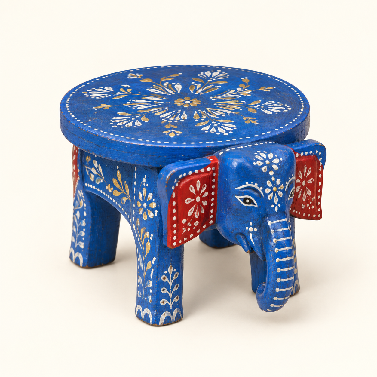 Blue elephant accent stand with a round painted top on an ivory background