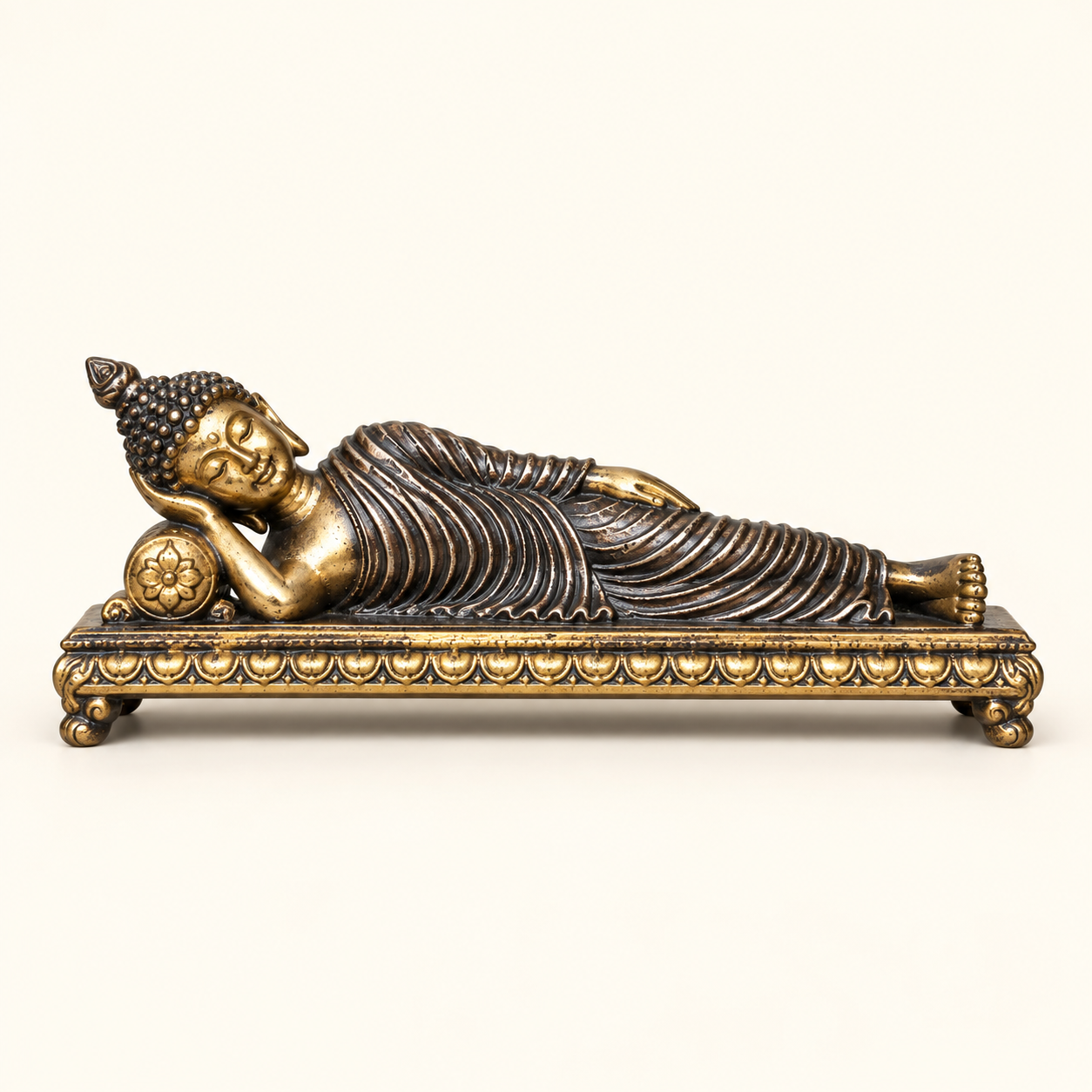 Reclining Buddha on an ivory studio background