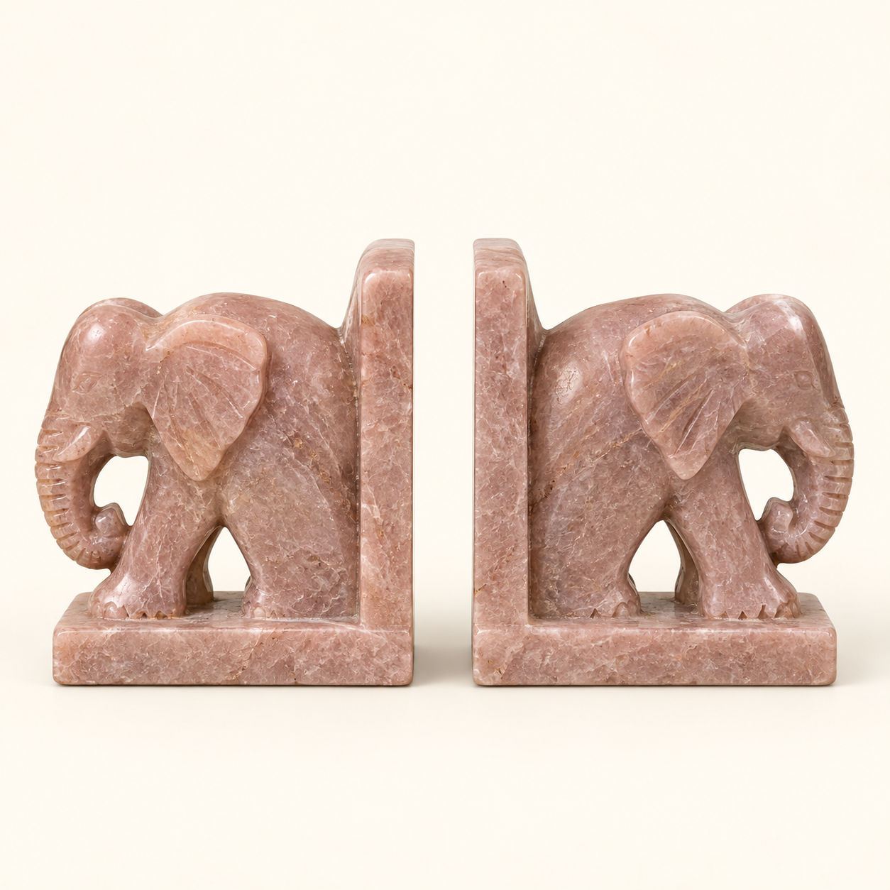 Carved Elephant Bookends on an ivory studio background